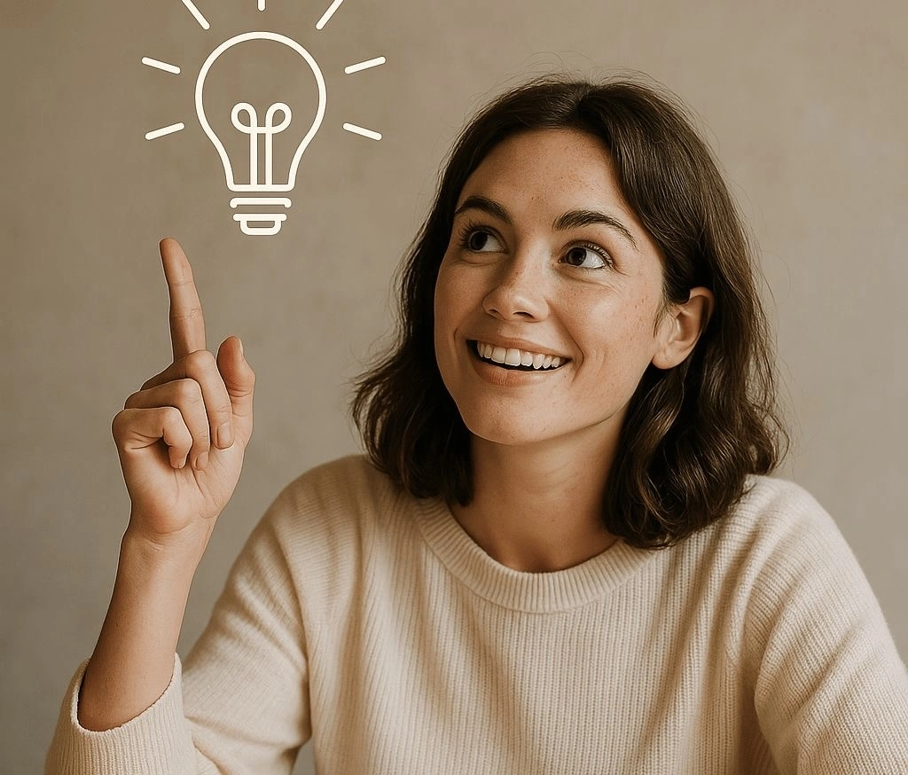 A smiling woman pointing upward toward a glowing lightbulb icon, symbolizing a new idea, inspiration, or creative thinking.