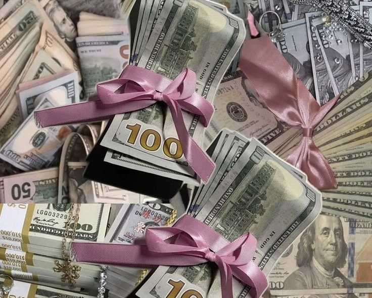 Stacks of US dollar bills tied with pink ribbons, arranged like gifts, symbolizing money, luxury, and financial rewards.
