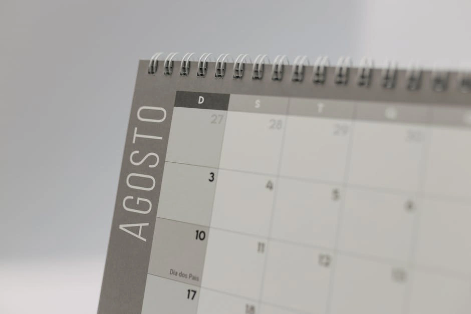 Detailed close-up of a spiral-bound calendar displaying the month of August.