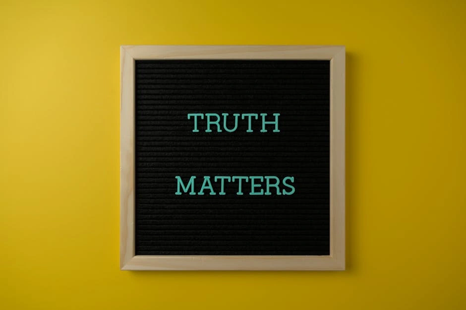 Close-up of black letter board with 'Truth Matters' message on yellow background.