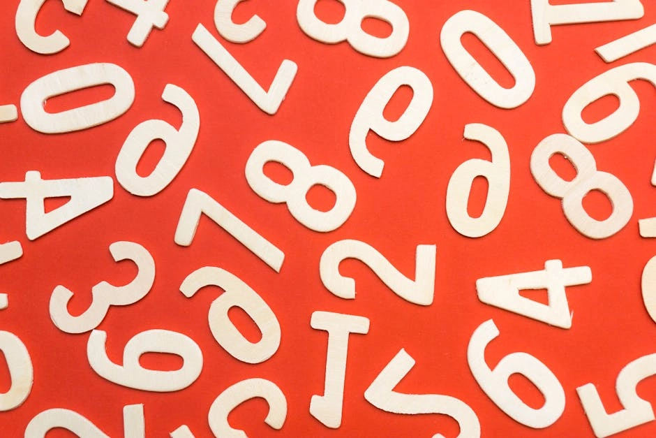Abstract flat lay of white numbers on red background.
