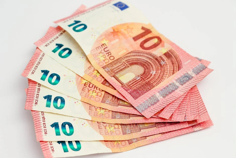 Close-up of a fan of 10 euro banknotes on a clean white background, showcasing European currency.