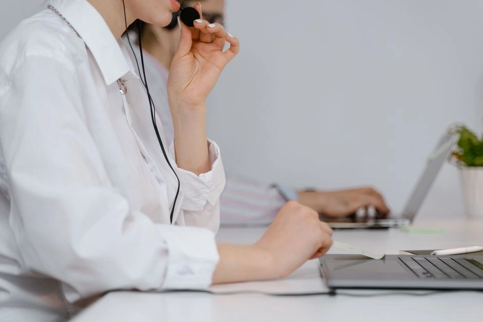 Support worker wearing a headset at a helpline desk