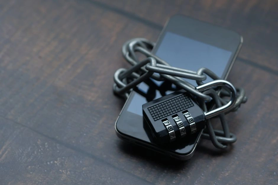 Smartphone wrapped in a chain with a combination padlock